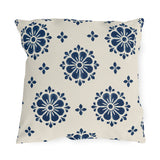 Navy block print outdoor pillow with flower medallions and small buds on warm white
