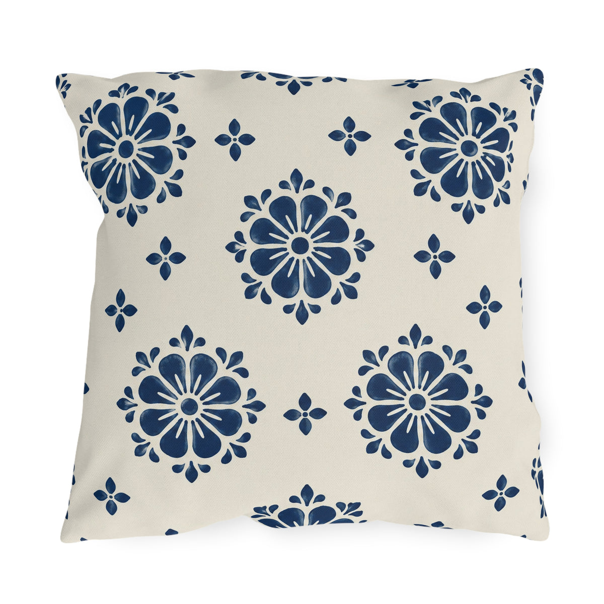 Navy block print outdoor pillow with flower medallions and small buds on warm white