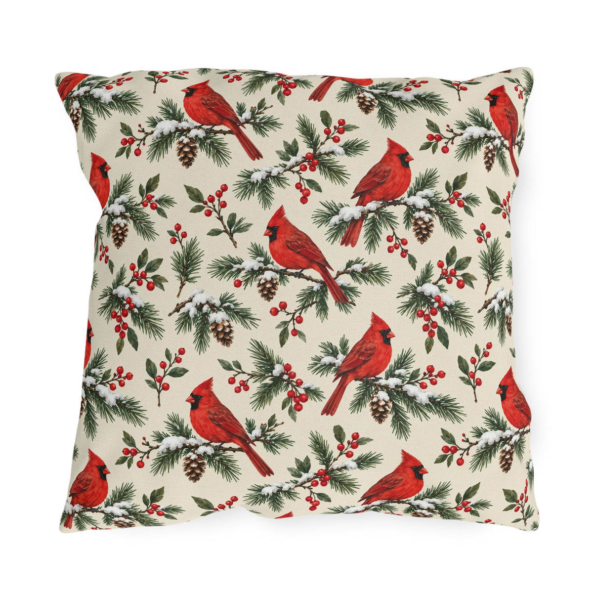 Christmas cardinal outdoor pillow with red cardinals, snowy pine sprigs, pinecones and red berries on soft cream