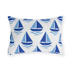 Coastal outdoor lumbar pillow with rows of cobalt and sky blue sailboats and waves on white