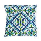 Blue and green Moroccan tile pattern on a white outdoor pillow