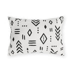 Black and white mudcloth outdoor lumbar pillow with hand-drawn arrows, diamonds and dashes in charcoal on warm white