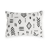 Black and white mudcloth outdoor lumbar pillow with hand-drawn arrows, diamonds and dashes in charcoal on warm white