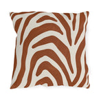 Modern outdoor pillow with bold rust zebra stripes on cream