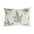 Green outdoor lumbar pillow with sage green eucalyptus sprigs tied with ribbon bows on cream
