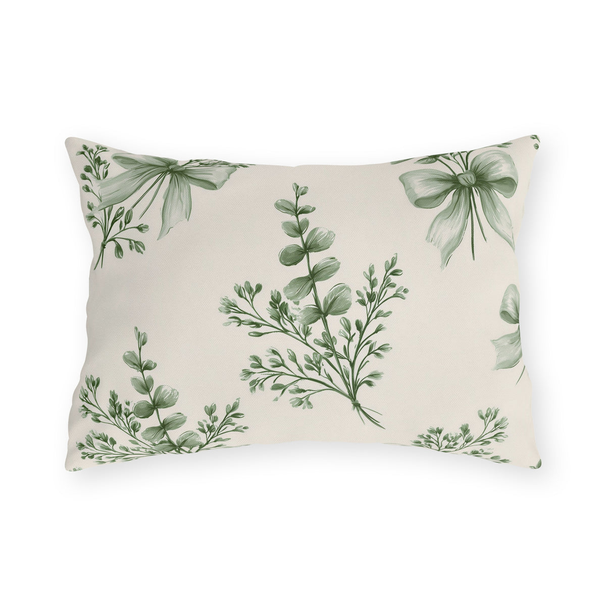 Green outdoor lumbar pillow with sage green eucalyptus sprigs tied with ribbon bows on cream