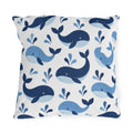 Coastal outdoor pillow with tossed navy and sky blue whales with water spouts on white