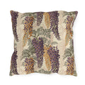 Cascading purple and amber wisteria with sage leaves on a cream outdoor pillow