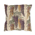 Cascading purple and amber wisteria with sage leaves on a cream outdoor pillow