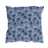 Navy and white poppies and seed heads on blue outdoor pillow