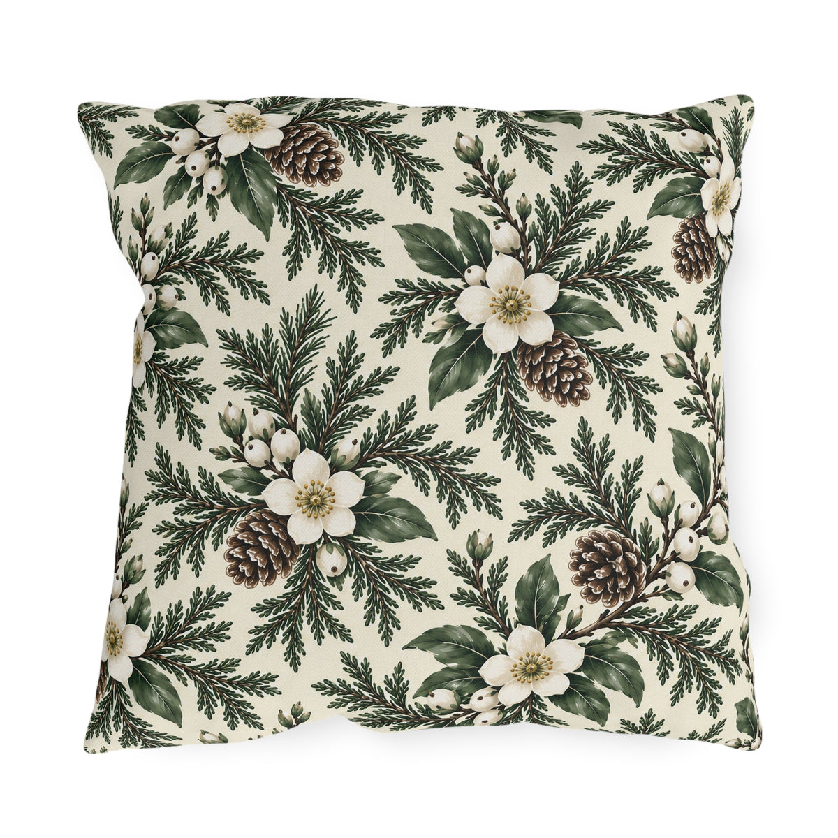 White winter roses, cedar, pinecones and white berries on a cream outdoor pillow