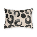 Black brush rings and solid dots on an oatmeal outdoor lumbar pillow