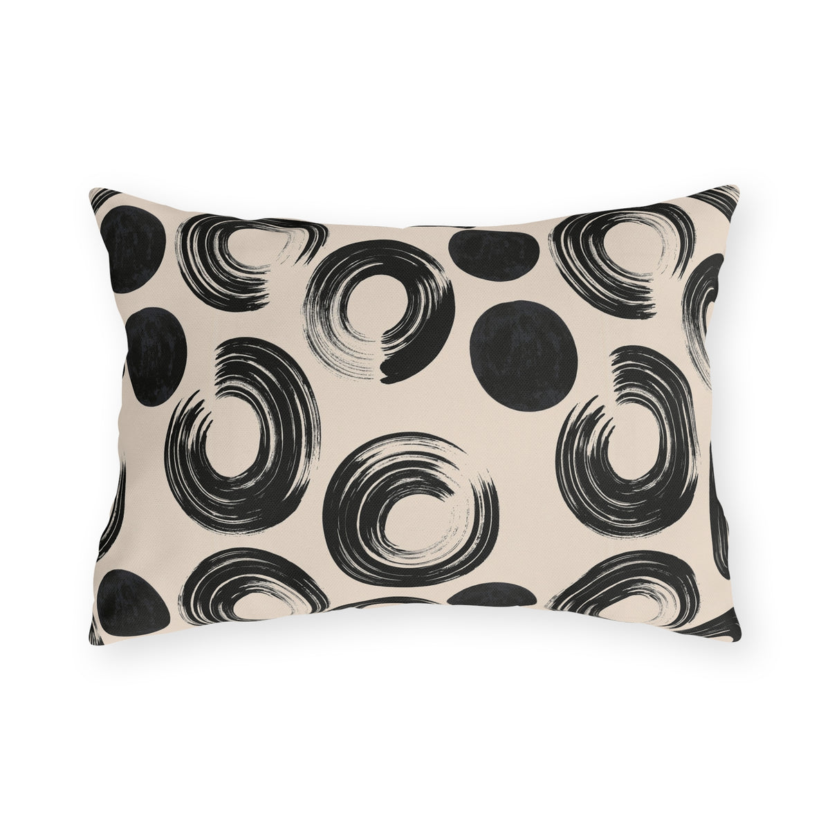 Black brush rings and solid dots on an oatmeal outdoor lumbar pillow