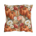 Orange pumpkins, cream chrysanthemums and wheat on warm brown outdoor pillow