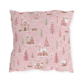 Snow-covered pink cottages and fir trees on pink outdoor pillow