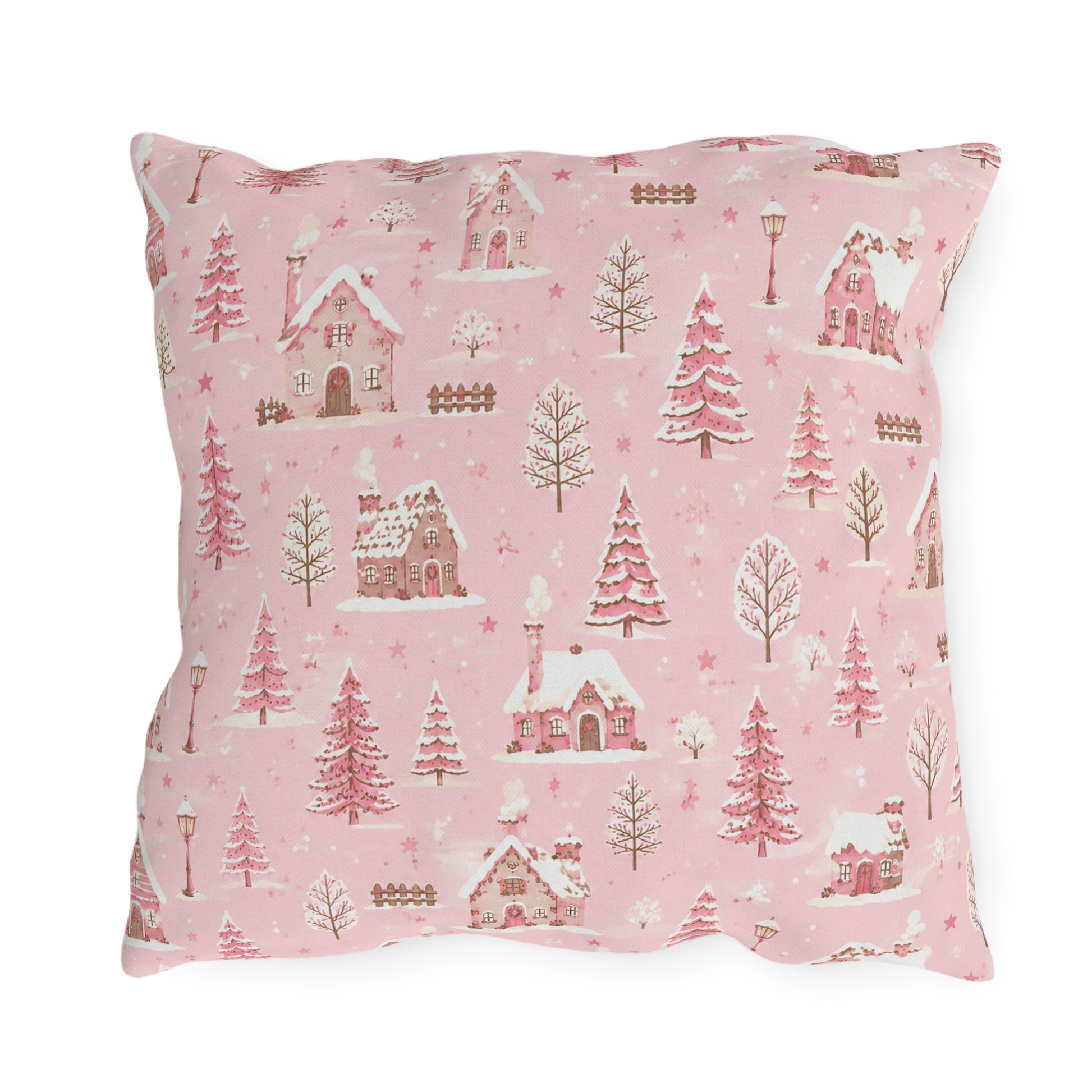 Snow-covered pink cottages and fir trees on pink outdoor pillow