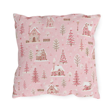 Snow-covered pink cottages and fir trees on pink outdoor pillow