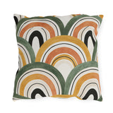 Overlapping ochre, terracotta and olive arches on a cream outdoor pillow