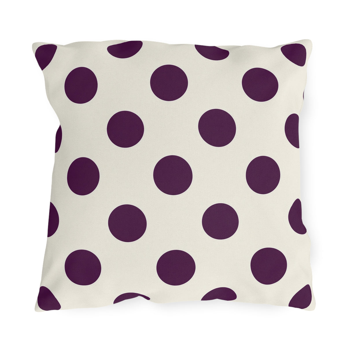 Aubergine polka dot outdoor pillow with large deep purple dots on cream