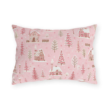 Snow-covered pink cottages and fir trees on pink outdoor lumbar pillow