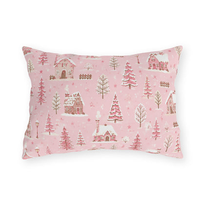 Snow-covered pink cottages and fir trees on pink outdoor lumbar pillow