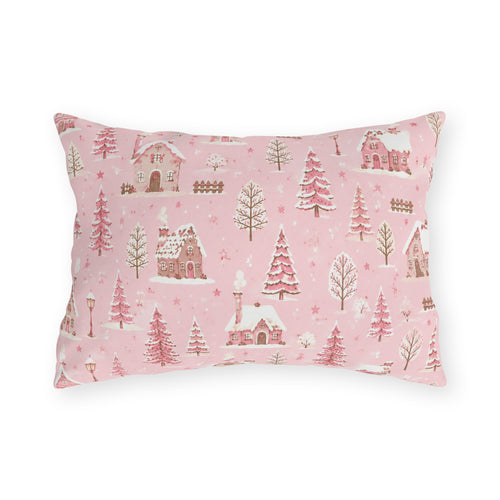 Snow-covered pink cottages and fir trees on pink outdoor lumbar pillow