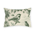 Green outdoor lumbar pillow with engraved toile songbirds, blossoms and bees on cream