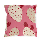 Modern outdoor pillow with cream and cherry red prickly pear cactus pads on bright pink