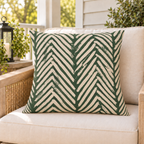 Green and oatmeal painted chevron outdoor pillow styled on patio furniture