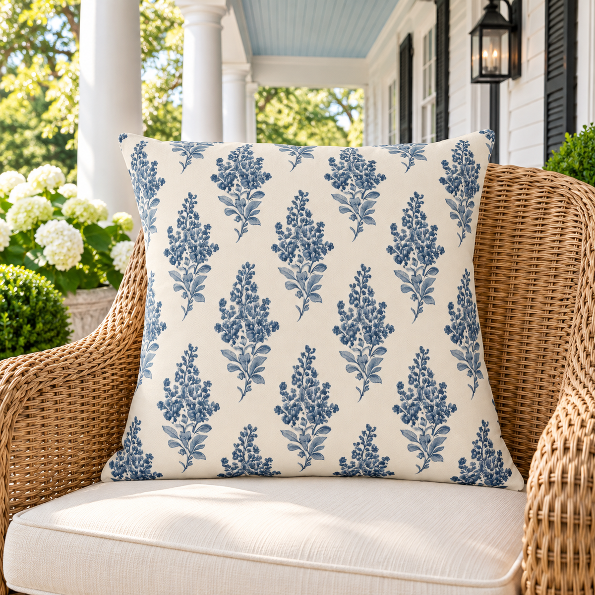 Blue botanical outdoor pillow on a classic porch
