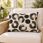 Oatmeal outdoor lumbar pillow with black brushed rings and dots, second view
