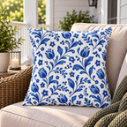 White outdoor pillow with scattered blue folk flowers, second view