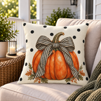 Black polka dot pumpkin outdoor pillow styled on a porch