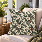 Cream outdoor pillow with white winter blooms and evergreen, second view