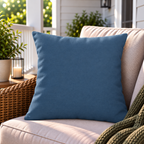 Solid slate blue outdoor pillow styled on patio furniture