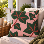 Pink and green ivy leaf outdoor pillow styled on patio furniture