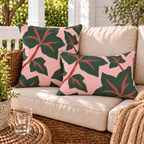 Pink and green ivy leaf outdoor pillow and outdoor lumbar pillow styled together as a set