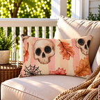 Pink skull and autumn leaf Halloween outdoor lumbar pillow styled on patio furniture