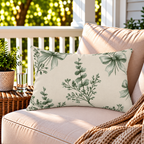 Sage green eucalyptus bow outdoor lumbar pillow styled on patio furniture