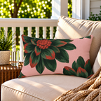 Pink and green dahlia floral outdoor lumbar pillow styled on patio furniture