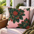 Pink and green dahlia floral outdoor pillow styled on patio furniture