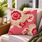 Pink and red peony floral outdoor pillow styled on patio furniture