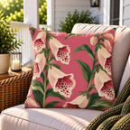 Pink foxglove floral outdoor pillow styled on patio furniture