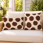 Brown and cream painted polka dot outdoor pillow and outdoor lumbar pillow styled together as a set