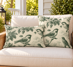 Green toile songbird outdoor pillow and outdoor lumbar pillow styled together as a set