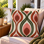 Rust and green retro ogee outdoor pillow styled on patio furniture
