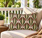 Green and rust retro ogee outdoor lumbar pillow styled on patio furniture