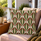 Green and rust retro ogee outdoor pillow styled on patio furniture