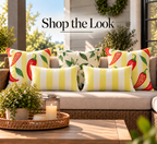 Chili pepper, pepper blossom and yellow cabana stripe outdoor pillows styled together on a porch sofa