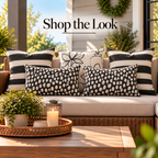 Bold stripe, line vase and painted dot outdoor pillows in black and cream styled together on a porch sofa